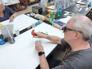 Participant holding a clamp and drawing it with their non dominant hand