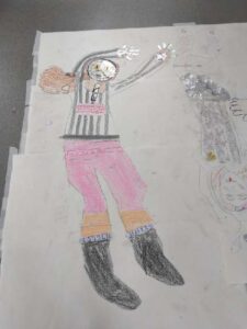 Figure in pink trousers and black and white stripped top