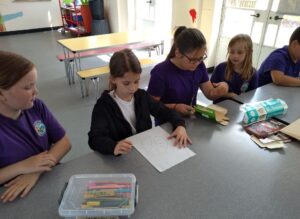 A pupil looking at their drawing