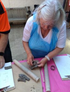 Participant making engine part clay slab
