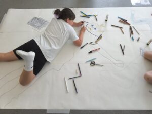 Pupil drawing details on their outline