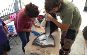 Plaster being poured into the shield mold