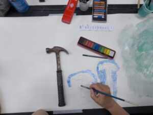 Participant painting drawing of a hammer