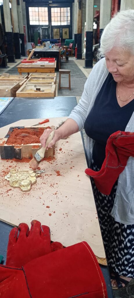 Participants giving the pewter model a brush down