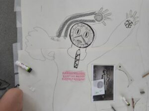 A figure with a clock for a face and arms raised up