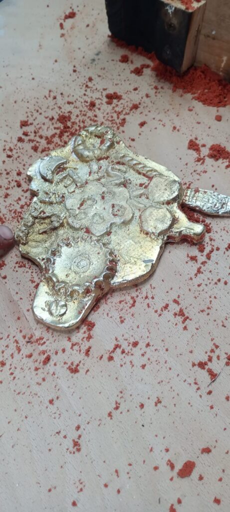 The finished pewter model with a golden sheen.