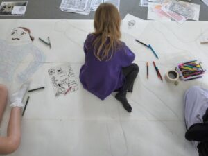 Pupil drawing details on their outline