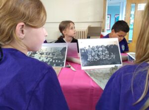 Pupils looking at photos of football teams