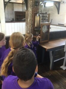 Creating a scene around the Work’s clock and whistle and the consequences of being late