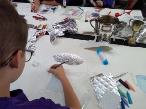 Pupil creating a cup collage