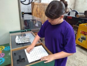 Pupil doing a rubbing the same piece of grating as a participant above