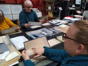 3 participants studying old technical drawings