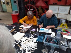 3 participants adding details for cyanotype