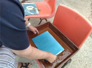 After the image has been exposed to the light for about 10 minutes, participant rinses the paper in clean water