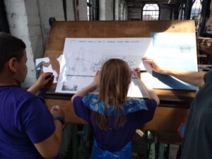 3 pupils tracing a technical drawing