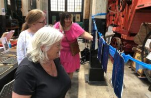 Participants looking cyanotypes drying