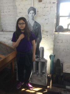 An Extra Time player stands beside a life-size model of a munitionette