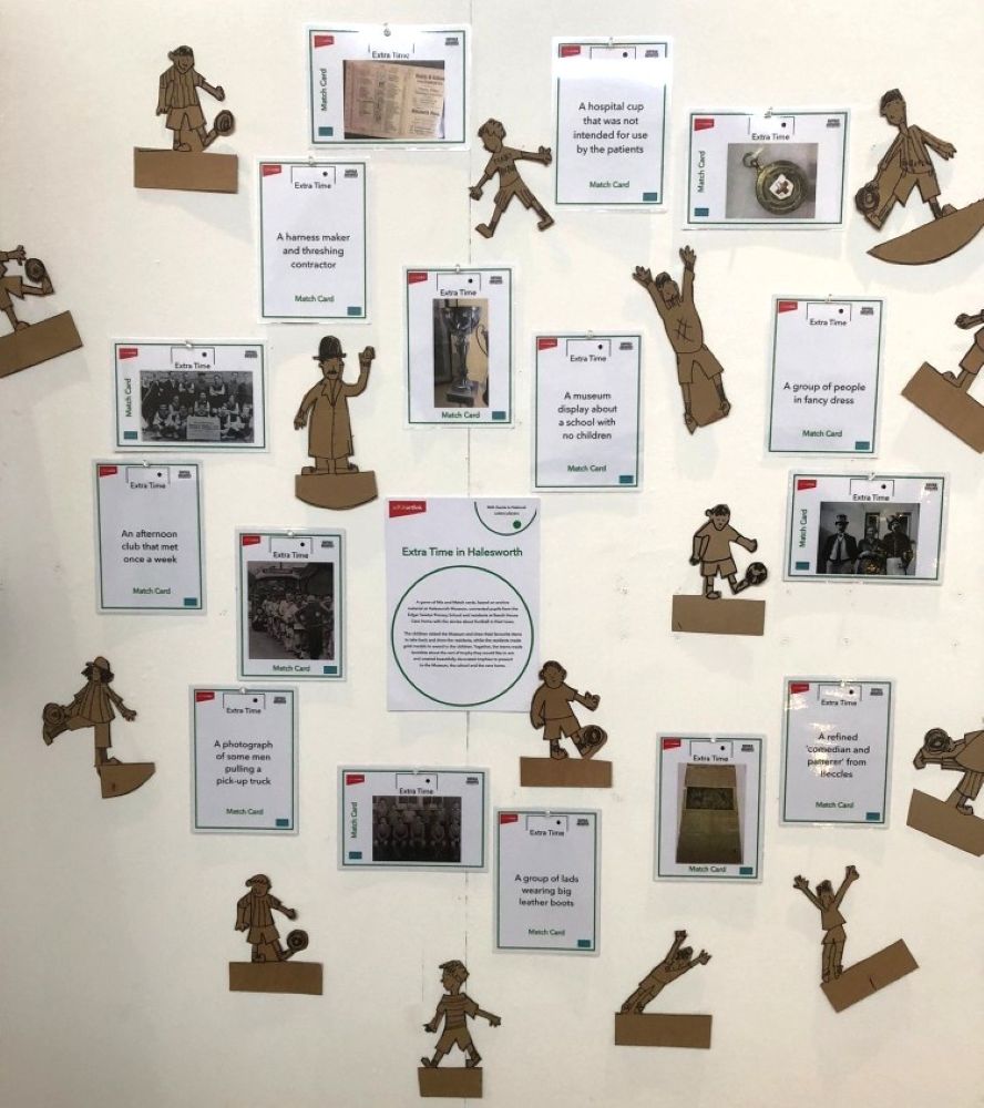A display of cardboard football figures and A5 cards with images and text relating to football. These are exhibits from the Extra Time programme in Halesworth