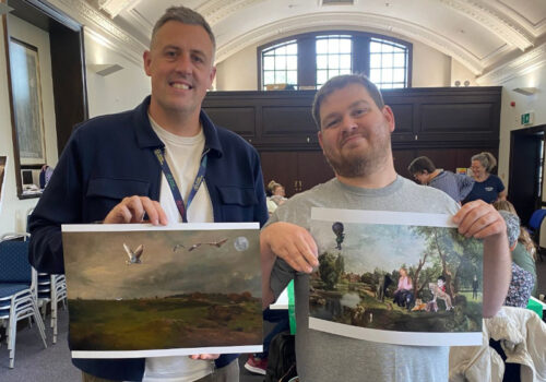 Guy and Will holding up copies of Will’s digital collages.
