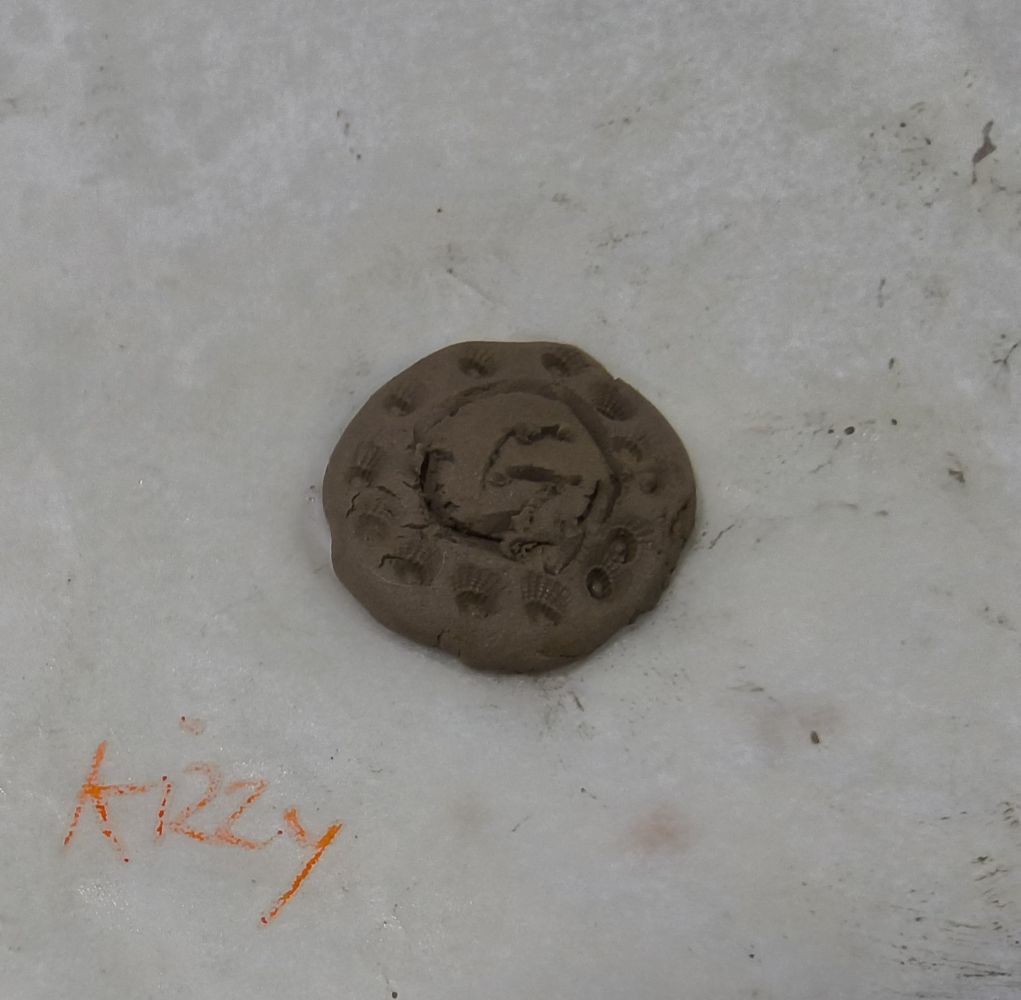 Clay disc. Kizzy