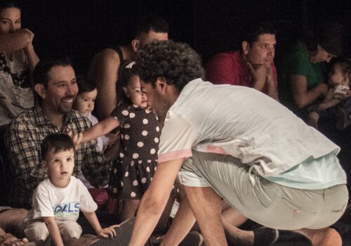 Performer crouching in front of audience
