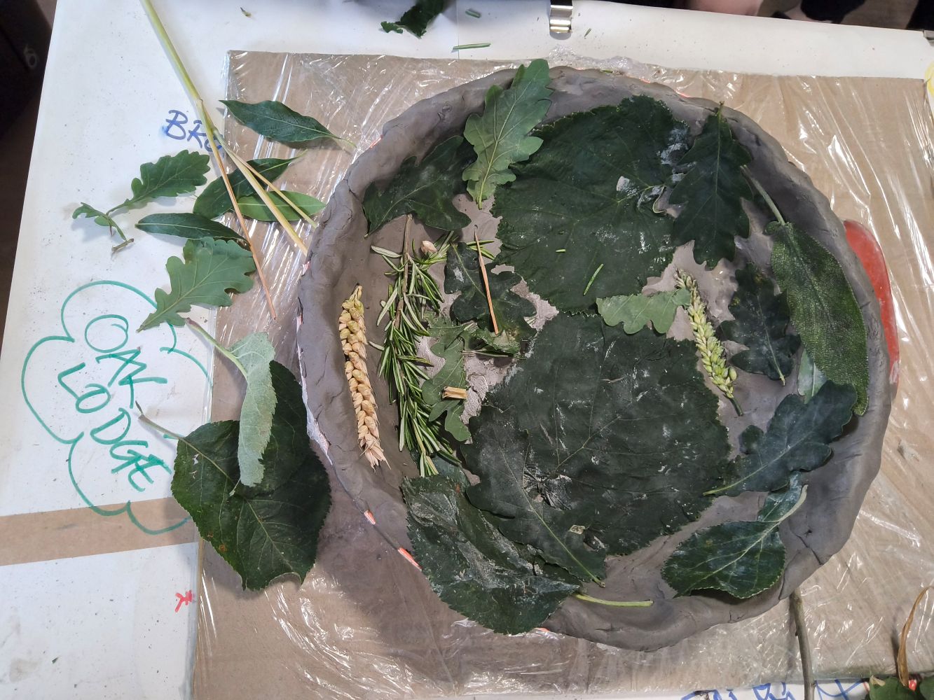 A clay bowl inlaid with leaves and grasses