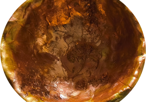 A large clay bowl decorated in gold leaf