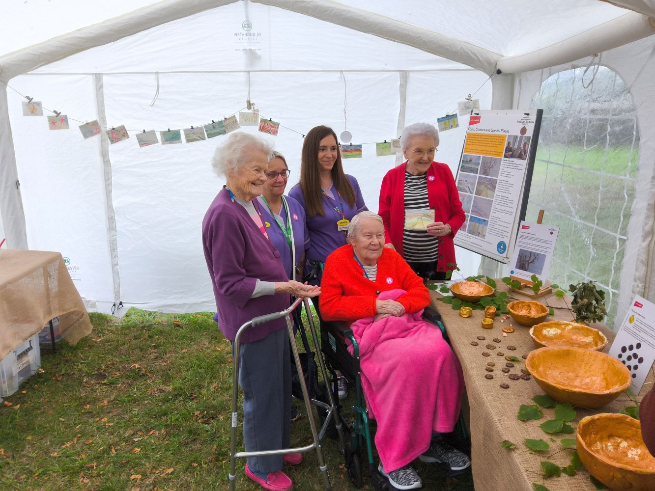 Staff and residents from De Lucy House Care Home looking at the bowls they made